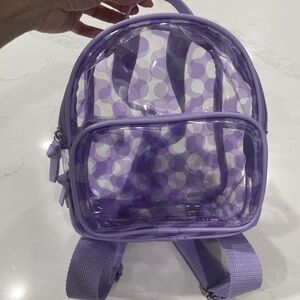 Purple and clear mini backpack. Good condition. No flaws.